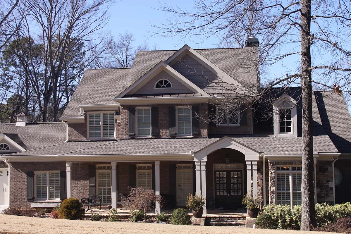 Large two-story home with steep roof of composite shingles