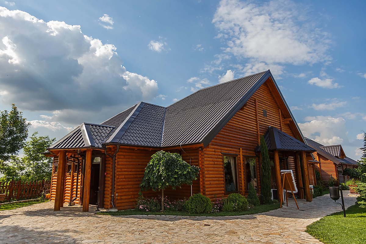 Cabin with stylish metal roofing tiles on a sunny day