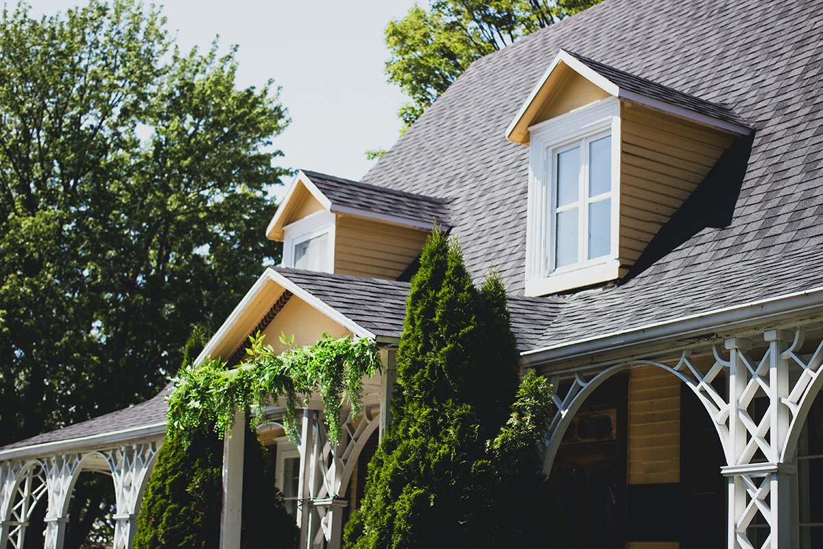 Steep composition shingle roof with small dormer windows